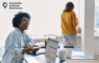 Mulher utiliza, através de seu laptop, o Domicílio Judicial Eletrônico